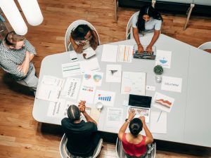 team viewed from overhead undertaking a hotel competitor analysis