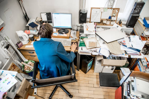 highly disorgaised desk with papers everywhere used in a blog highlighting the benefits of system integration