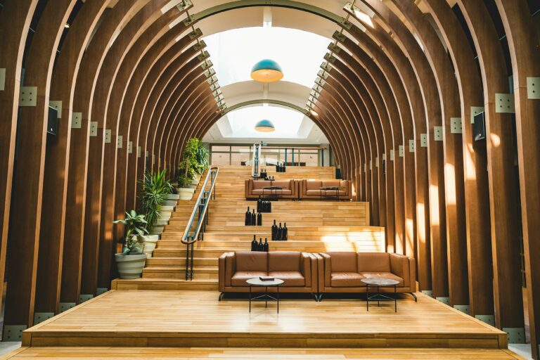 large hotel foyer with curved walls and steps leading to a large glass window used on a blog about the latest hospitality trends for 2025