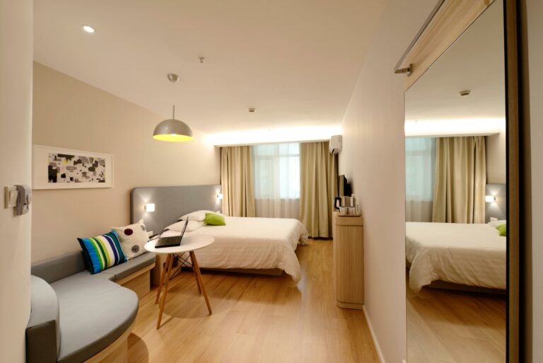 hotel room with a bed, small table and sofa used on a blog about hotel listing parity
