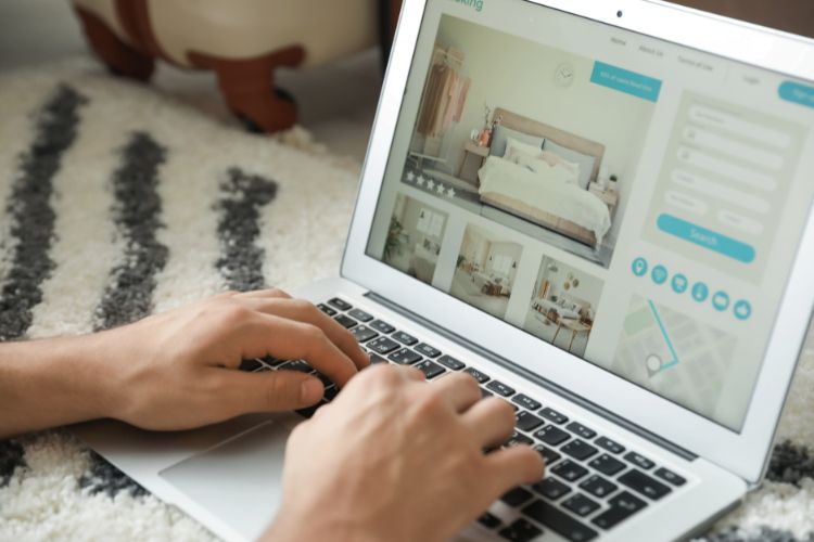 making a hotel reservation online on a laptop used on a blog about an integrated payment gateway